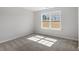 Comfortable bedroom with neutral carpeting and a window for natural lighting at 319 N Maple Walk # 213, Garner, NC 27529