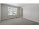 Bright bedroom features carpeted floors and a view of the neighborhood at 319 N Maple Walk # 213, Garner, NC 27529