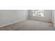 Cozy bedroom with carpet flooring and natural light from the window at 319 N Maple Walk # 213, Garner, NC 27529