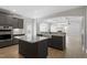This kitchen features an island and opens to a living space with detailed ceiling and light fixtures at 319 N Maple Walk # 213, Garner, NC 27529