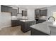 This kitchen features a spacious island, gray cabinets, stainless steel appliances, and quartz countertops at 319 N Maple Walk # 213, Garner, NC 27529