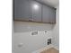 Laundry room featuring upper cabinets, and hookups for a washer and dryer at 319 N Maple Walk # 213, Garner, NC 27529