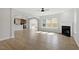 Open-concept living room featuring hardwood floors, a fireplace, and an abundance of natural light at 319 N Maple Walk # 213, Garner, NC 27529