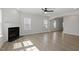 Spacious living room with a fireplace, hardwood floors, and arched openings to other living areas at 319 N Maple Walk # 213, Garner, NC 27529