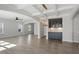 Open-concept living space featuring hardwood floors, coffered ceilings, and a stylish light fixture over the bar at 319 N Maple Walk # 213, Garner, NC 27529