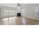 Bright living room with hardwood floors, a fireplace, and large windows providing plenty of natural light at 319 N Maple Walk # 213, Garner, NC 27529