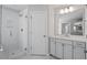 Bright bathroom featuring a glass enclosed shower, white cabinets, and a well-lit vanity mirror at 322 N Maple Walk Walk # 237, Garner, NC 27529