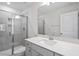 Bathroom with tiled shower and glass door at 322 N Maple Walk Walk # 237, Garner, NC 27529