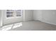 Bright bedroom featuring plush carpeting, neutral walls, and a bright window at 322 N Maple Walk Walk # 237, Garner, NC 27529