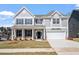 Charming two-story home with gray siding, stone accents, and a well-manicured front yard at 322 N Maple Walk Walk # 237, Garner, NC 27529