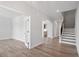 Bright foyer with hardwood floors, staircase, and arched doorways leading to other rooms at 322 N Maple Walk Walk # 237, Garner, NC 27529