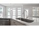 Close-up of a kitchen island and sink featuring a modern faucet and stainless dishwasher at 322 N Maple Walk Walk # 237, Garner, NC 27529