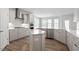 Spacious kitchen with stainless steel appliances, white cabinets, and a center island at 322 N Maple Walk Walk # 237, Garner, NC 27529