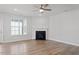 Bright living room showcasing a fireplace, ceiling fan, and views to the backyard at 322 N Maple Walk Walk # 237, Garner, NC 27529