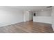 Spacious living room features hardwood floors, neutral paint, and plenty of natural light at 322 N Maple Walk Walk # 237, Garner, NC 27529