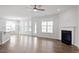 Open-concept living area featuring a fireplace and connection to the kitchen and dining area at 322 N Maple Walk Walk # 237, Garner, NC 27529