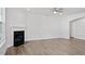Spacious living room with a fireplace, ceiling fan, and wood-look flooring at 322 N Maple Walk Walk # 237, Garner, NC 27529