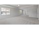 Spacious primary bedroom with neutral carpet, ceiling fan, and many windows at 322 N Maple Walk Walk # 237, Garner, NC 27529
