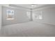 Large primary bedroom with ample natural light, neutral carpeting, and tray ceiling at 322 N Maple Walk Walk # 237, Garner, NC 27529
