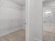 Walk-in closet featuring carpet floors, open wire shelving, and ample storage space at 347 N. Maple Walk Dr # 211, Garner, NC 27529