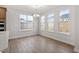 Bright dining room with hardwood floors and large windows, complete with modern lighting fixture at 347 N. Maple Walk Dr # 211, Garner, NC 27529