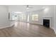 Open concept living room with hardwood floors, fireplace, kitchen island, and plenty of natural light at 347 N. Maple Walk Dr # 211, Garner, NC 27529