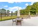 Community pool area with lounge chairs, tables and views of the pond at 347 N. Maple Walk Dr # 211, Garner, NC 27529