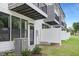 Modern townhouse rear view with dark trim, white fences, and air conditioning units at 4093 Elk Crk Ln, Raleigh, NC 27612