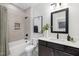 Chic bathroom with a modern vanity, stylish mirror, and a bathtub featuring tiled walls and sleek fixtures at 4095 Elk Crk Ln, Raleigh, NC 27612