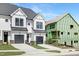 Modern townhome exterior with black and white design elements and two-car garage at 4095 Elk Crk Ln, Raleigh, NC 27612