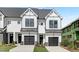 Modern townhome exterior with black and white design elements and two-car garage at 4095 Elk Crk Ln, Raleigh, NC 27612