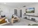 Bright living room with gray walls, neutral furniture, and a wall-mounted television at 4095 Elk Crk Ln, Raleigh, NC 27612