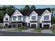 Charming townhomes with white siding, black accents, garage, and landscaping at 4095 Elk Crk Ln, Raleigh, NC 27612