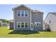 New construction home features a spacious backyard, gray siding, and bright white window trim at 41 Silver Moon Ln # 115, Clayton, NC 27527