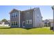 New construction two-story home with a manicured lawn and gray siding and plenty of windows at 41 Silver Moon Ln # 115, Clayton, NC 27527