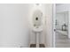 Stylish powder room with a pedestal sink, modern mirror, and fresh decor at 41 Silver Moon Ln # 115, Clayton, NC 27527