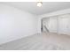 Well-lit bedroom with neutral carpeting and a view into a bathroom, alongside two closets at 41 Silver Moon Ln # 115, Clayton, NC 27527