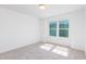 Bright bedroom with natural light, neutral carpeting, and a double-hung window at 41 Silver Moon Ln # 115, Clayton, NC 27527
