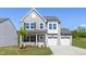 Charming two-story home featuring gray siding, a two-car garage, and a well-manicured front lawn at 41 Silver Moon Ln # 115, Clayton, NC 27527