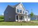 Gray two-story home with charming front porch, two-car garage, and well maintained lawn at 41 Silver Moon Ln # 115, Clayton, NC 27527
