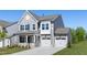 Charming home featuring gray siding, a two-car garage, and a well-maintained front lawn at 41 Silver Moon Ln # 115, Clayton, NC 27527
