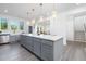 Bright and airy kitchen with gray cabinets, a center island, and stainless steel appliances at 41 Silver Moon Ln # 115, Clayton, NC 27527