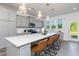 Modern kitchen with gray cabinets, stainless appliances, a large island, and stylish pendant lighting at 41 Silver Moon Ln # 115, Clayton, NC 27527