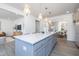 Open-concept kitchen with gray cabinets, a large island, and modern pendant lighting at 41 Silver Moon Ln # 115, Clayton, NC 27527