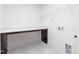 Functional laundry room with countertop space, wire shelving, and sleek tile flooring at 41 Silver Moon Ln # 115, Clayton, NC 27527