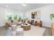 Bright living room featuring a modern sofa, stylish chairs, and a round coffee table on a neutral rug at 41 Silver Moon Ln # 115, Clayton, NC 27527