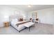 Spacious main bedroom features a comfortable bed, bench, and large windows for natural light at 41 Silver Moon Ln # 115, Clayton, NC 27527
