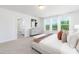 Bright main bedroom features an ensuite bath, plush carpet, and large windows with green backyard views at 41 Silver Moon Ln # 115, Clayton, NC 27527