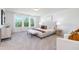 Serene main bedroom with large windows, plush carpet, and a comfortable bed with stylish bedding at 41 Silver Moon Ln # 115, Clayton, NC 27527