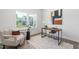Bright home office with a modern desk, comfortable chair, and large window overlooking the yard at 41 Silver Moon Ln # 115, Clayton, NC 27527